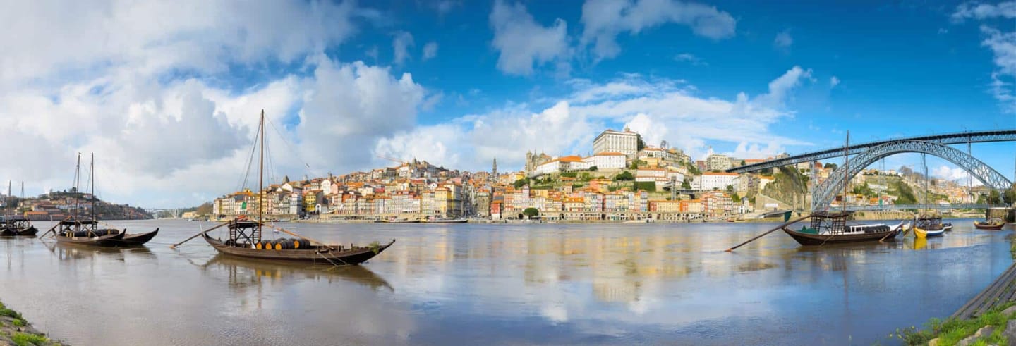 Rabelo boats on the Douro river in front of Porto's Ribeira district and the Dom Luís bridge